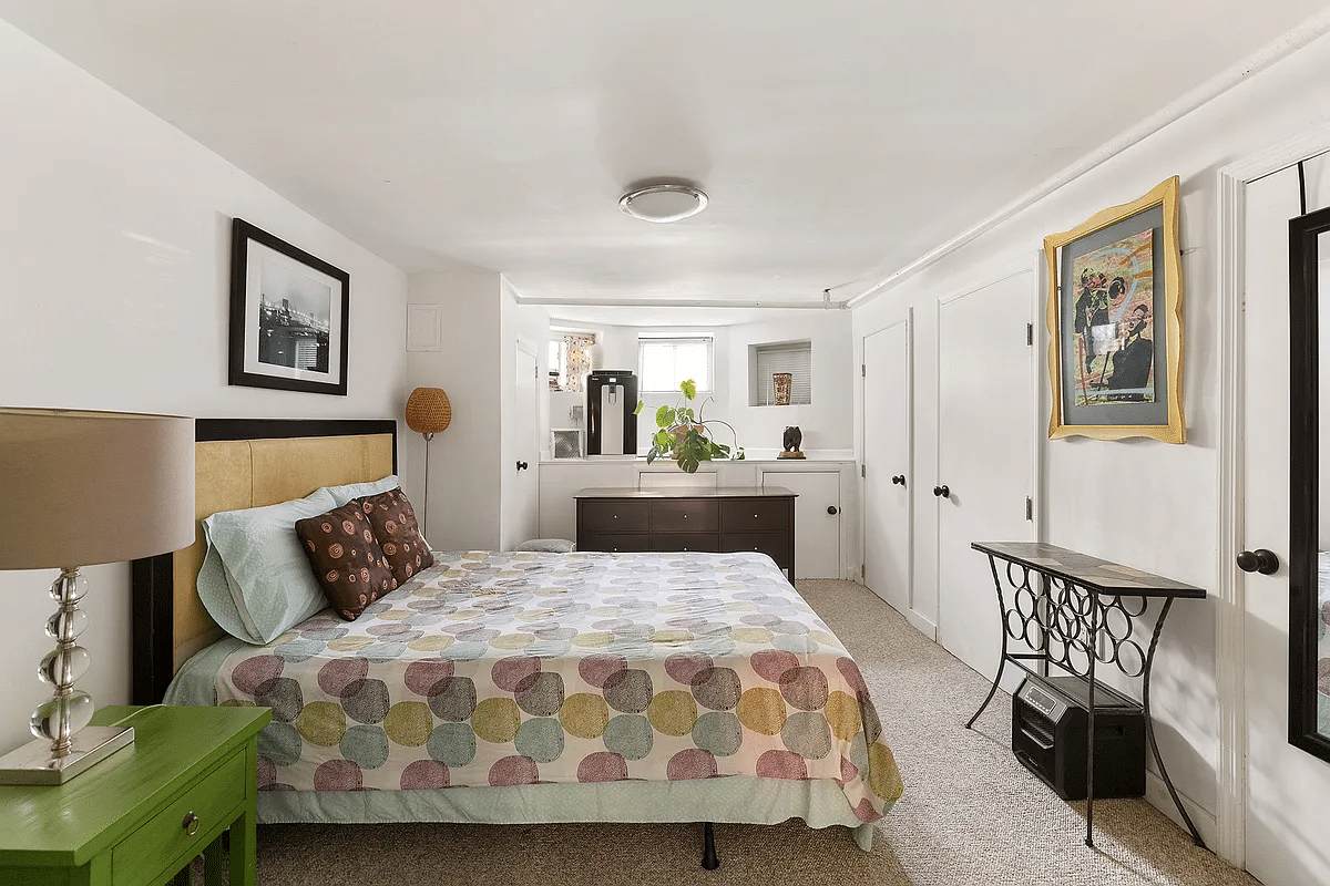 basement with below grade windows set up as a bedroom