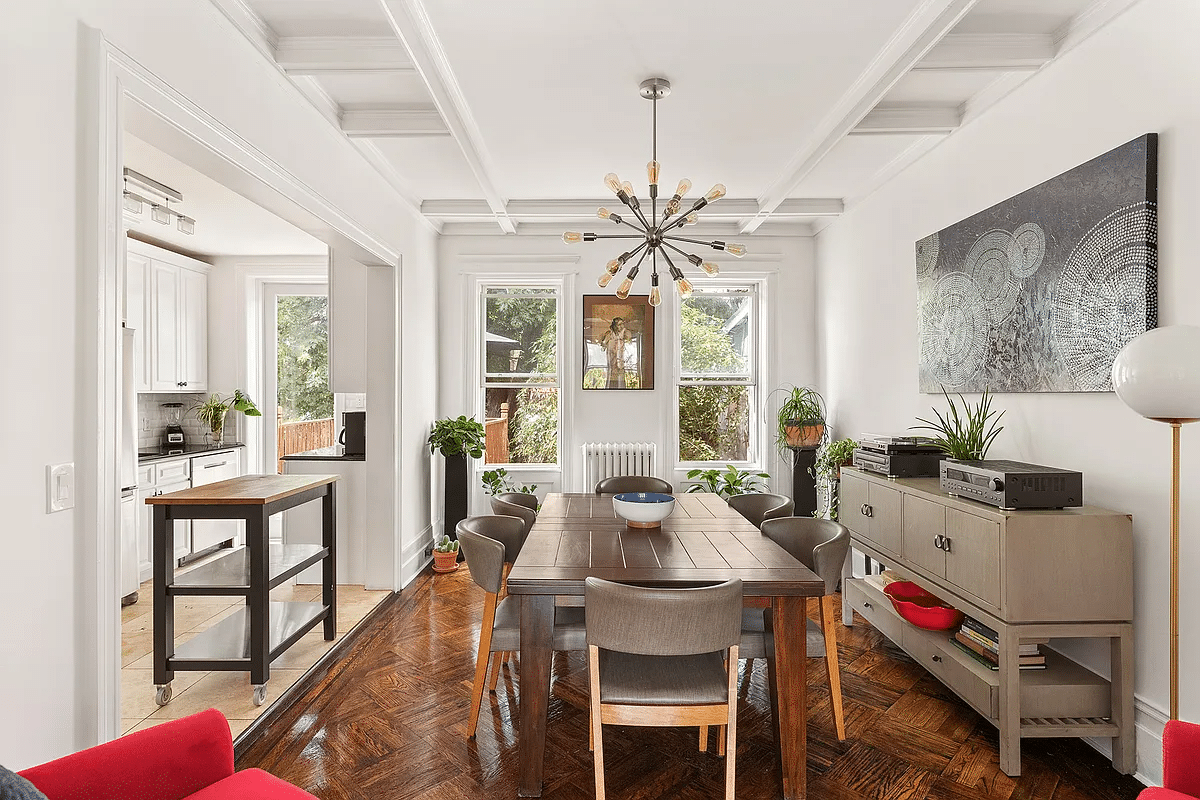 dining room with wood floor, small step up to kitchen