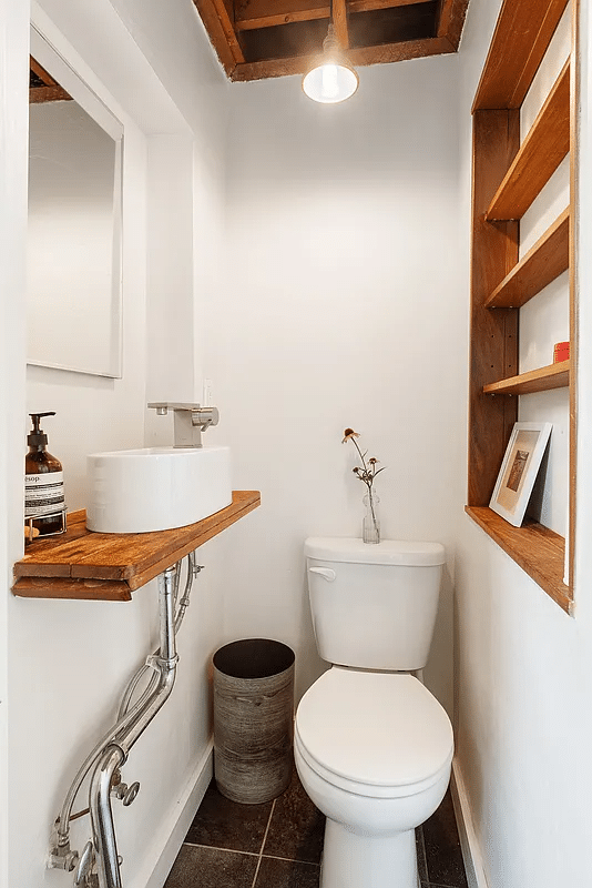 Guest toilet with exposed beams, sink on wood