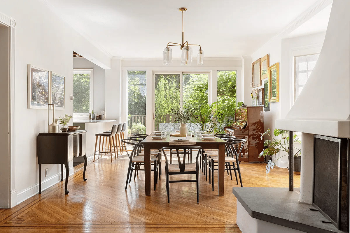 Dining room with wooden floor, glass back wall