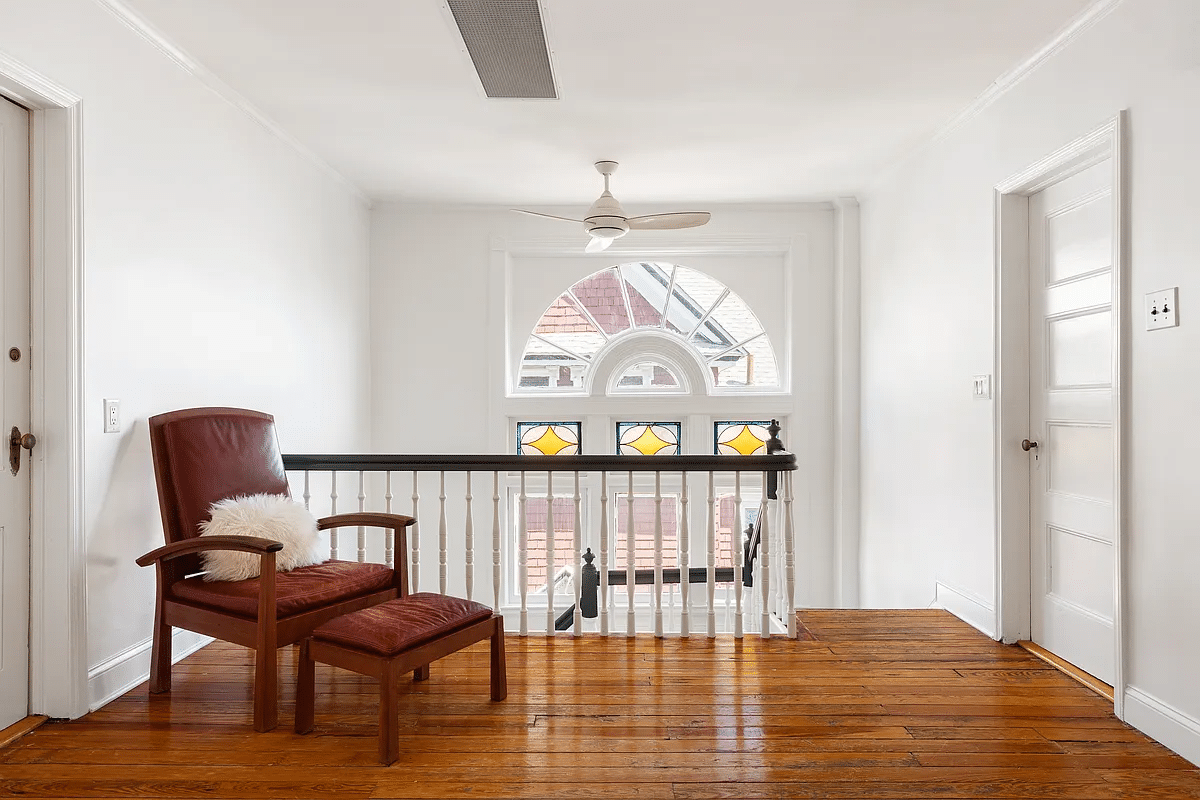 Upper floor landing with view of a Palladian window