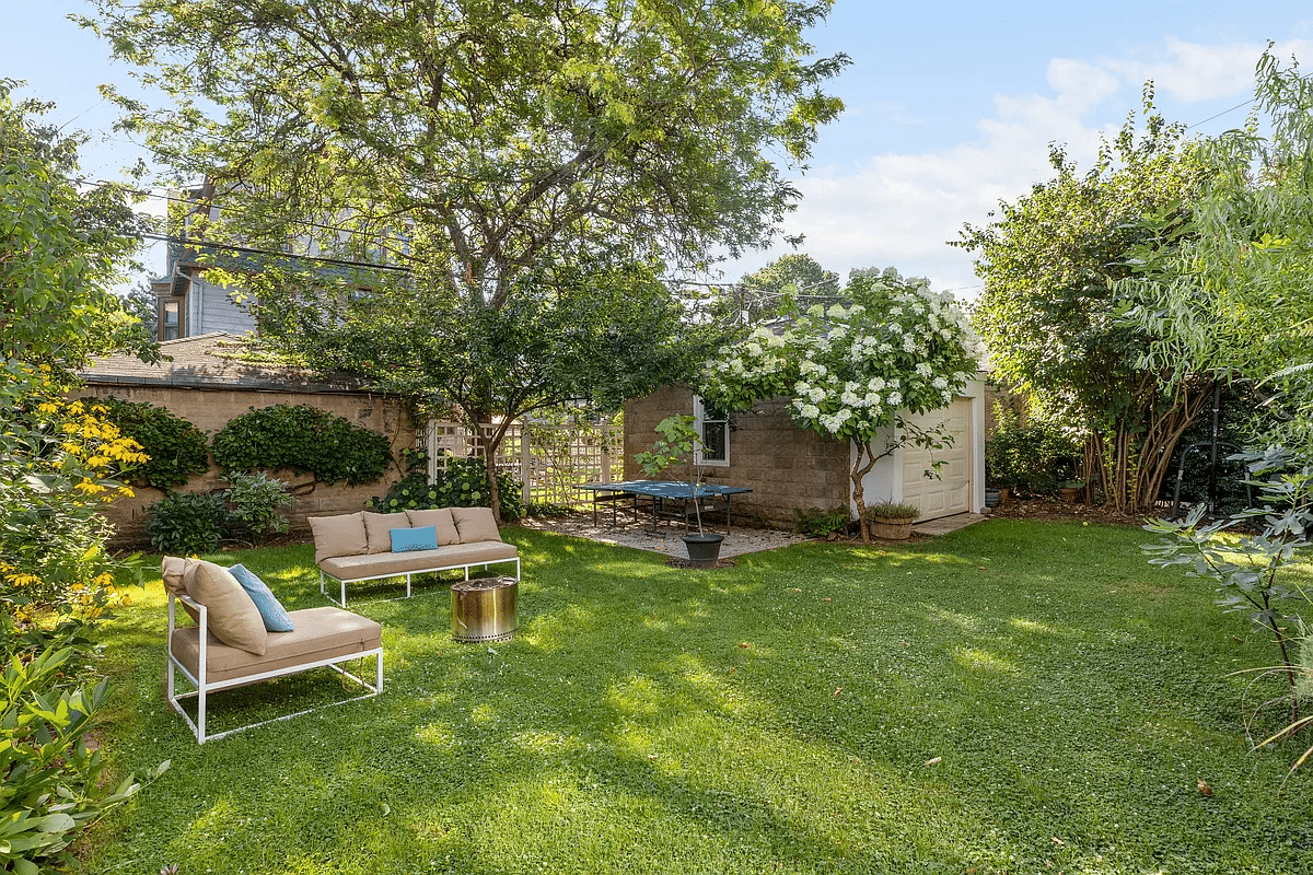 Backyard with lawn, trees and garage