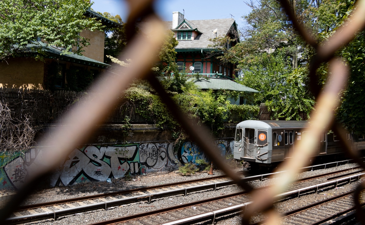 brooklyn - view of a b train on the sunken train tracks with houses of Prospect Park South in the background