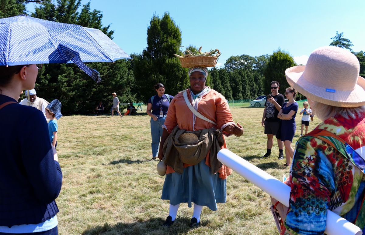 costumed interpretor shares a story with onlookers