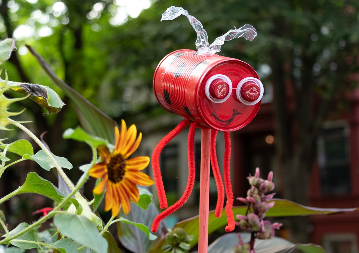 a lady bug made out of a tin can