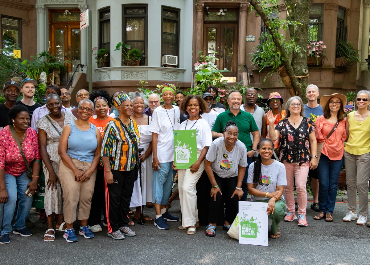 Greenest block - winners gathered in front of a staircase