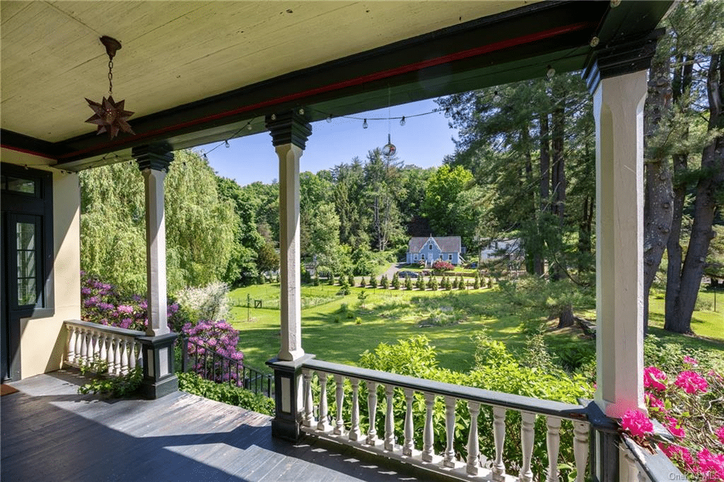 front porch with wood ceiling, columns and view of the yard