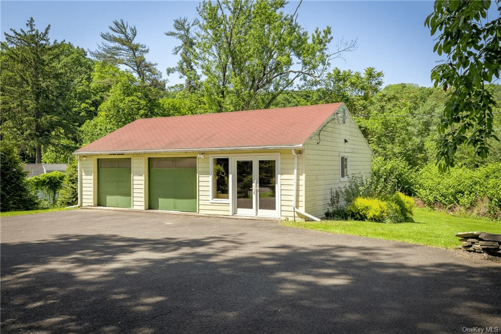 guest house painted yellow and with built-in garages