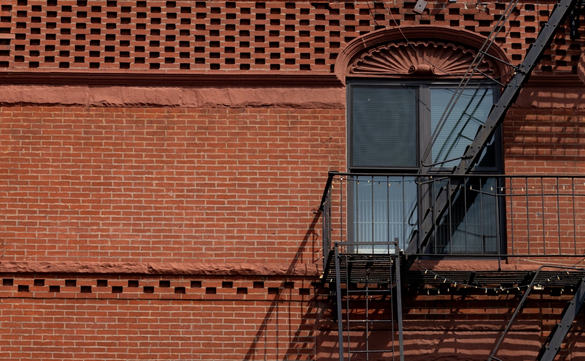 brooklyn - a fire escape on a red brick building