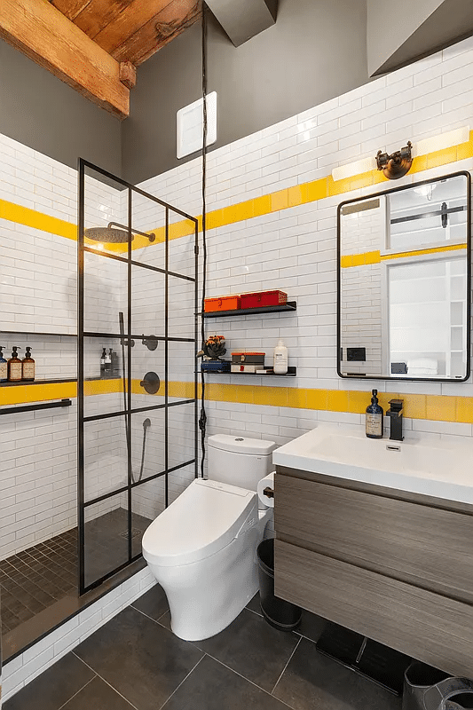 Bathroom with yellow accent tiles and walk-in shower