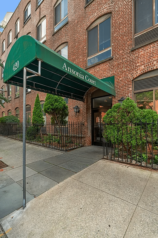 entrance with green awning with "ansonia court" displayed