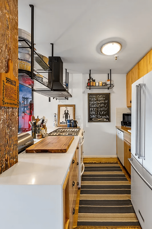 galley kitchen with wood cabinets and open to the living room