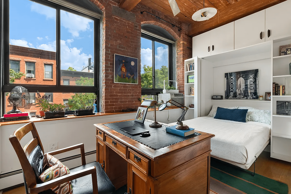 Bedroom furnished as a study with a wall bed