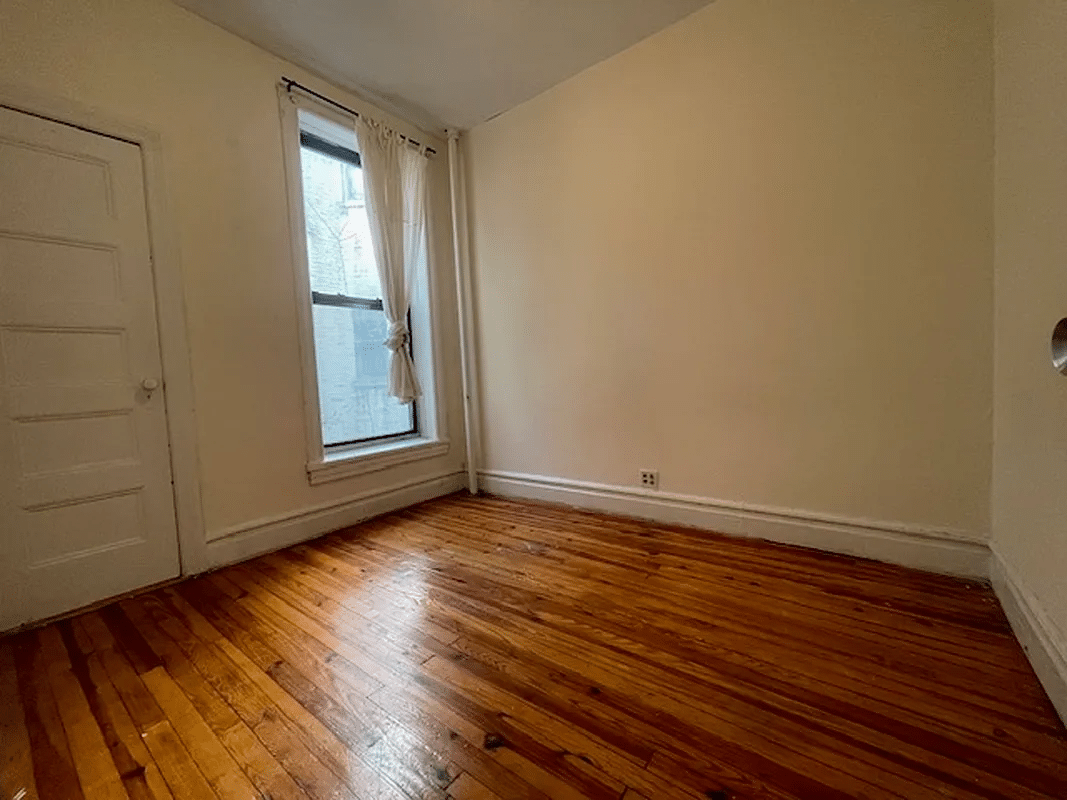 bedroom with closet, one window, wood floor