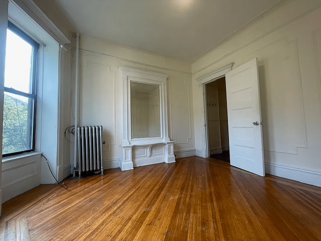 living room with wood floor, wall moldings