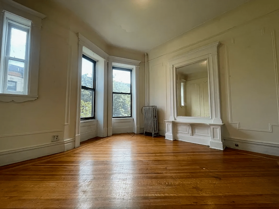 iving room with wall moldings, mirror