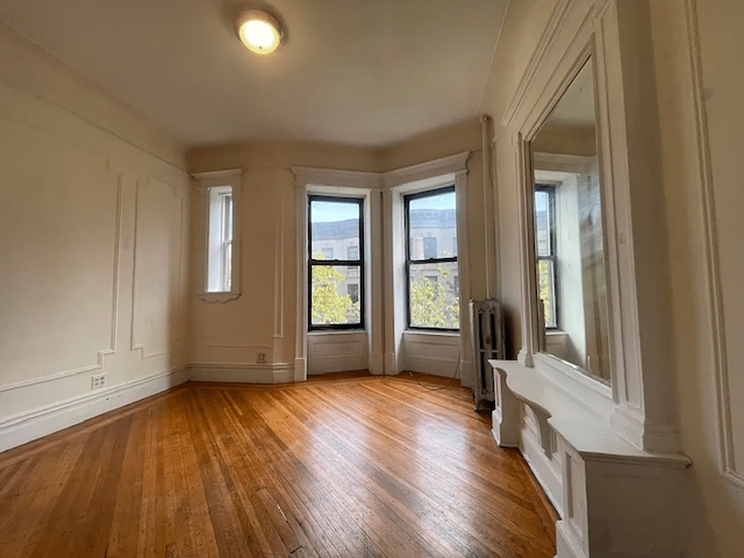 living room with wall moldings, mirror