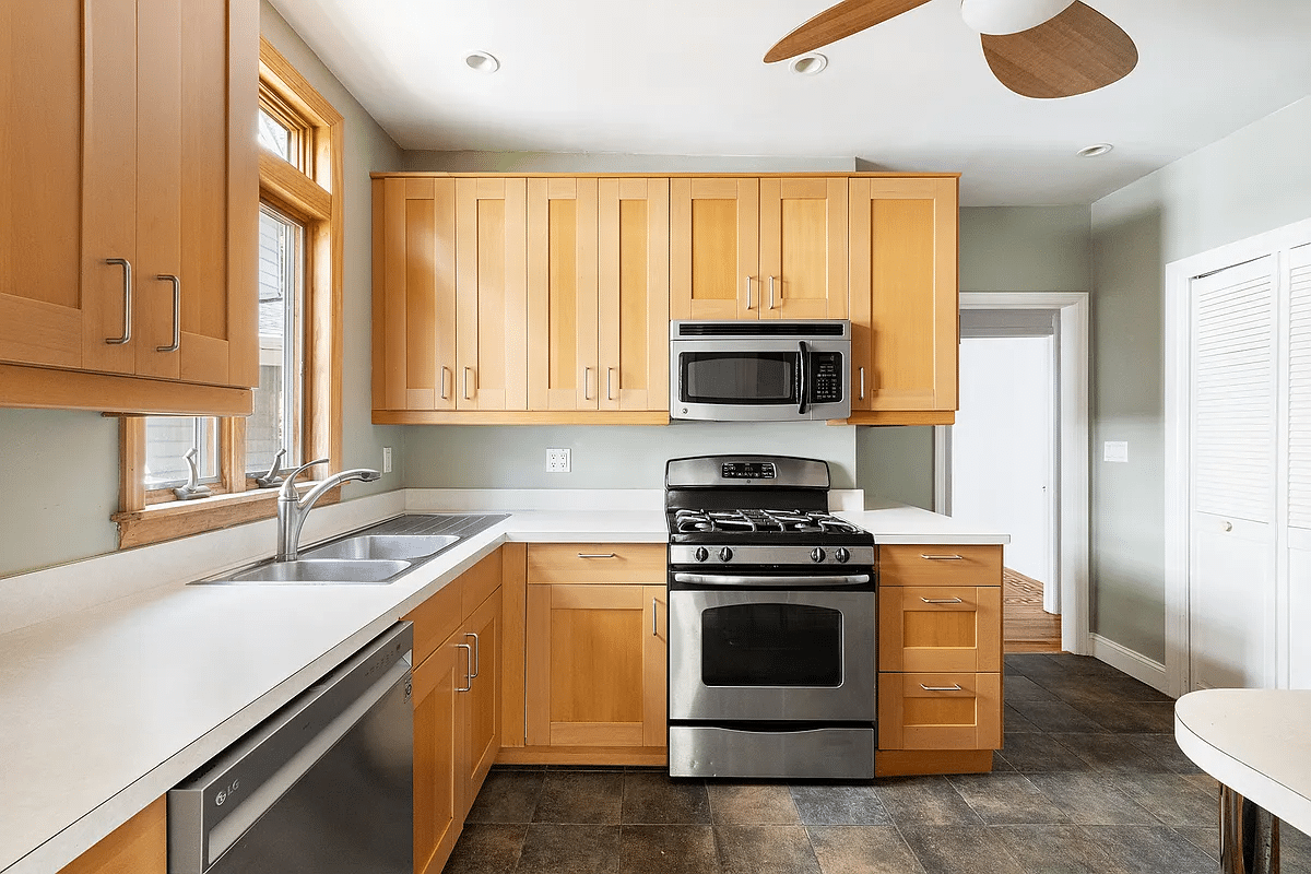 kitchen with tile floor, wood cabinets, white countertop