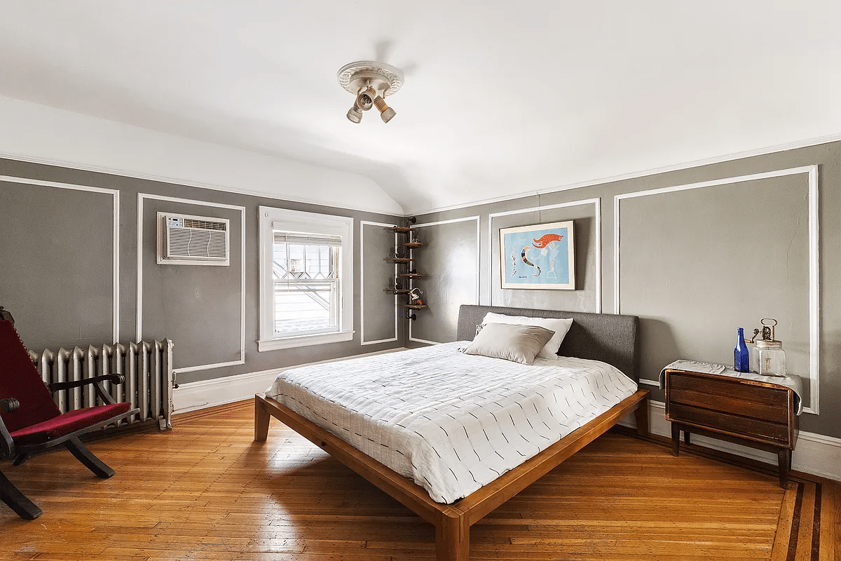 bedroom with wall moldings, picture rail