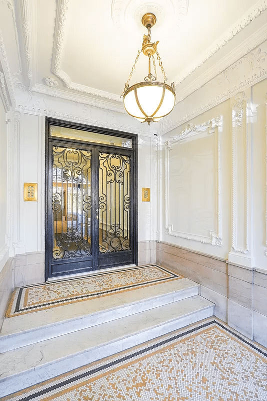 building entry with tile floor and wall moldings