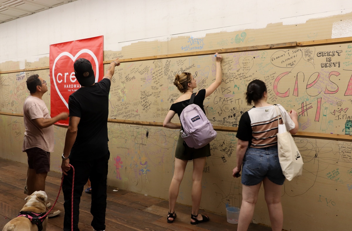 people signing the wall