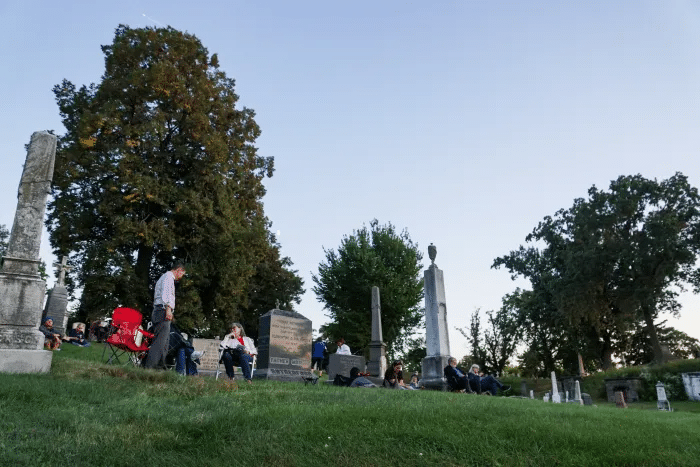 people walking through the cemetery