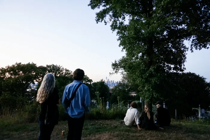 people walking through the cemetery