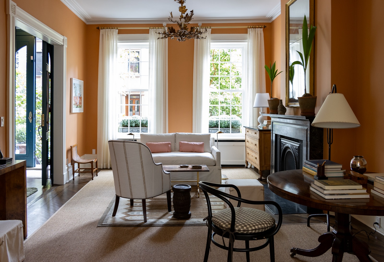 parlor with white upholstered furniture and a black marble mantel