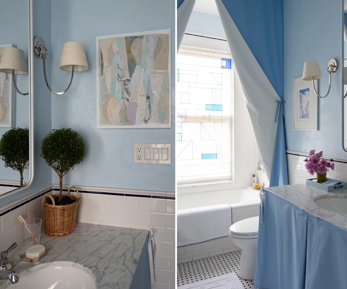 a blue bathroom with a silk shade