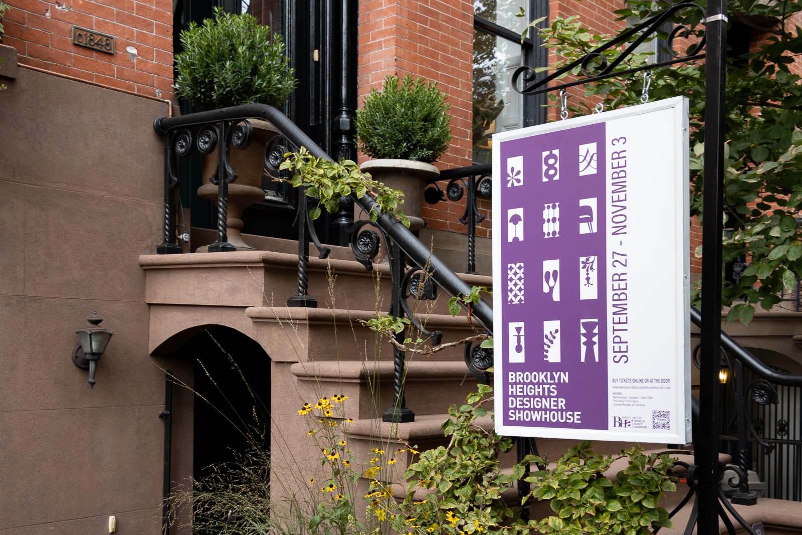 The exterior of the showhouse with a sign