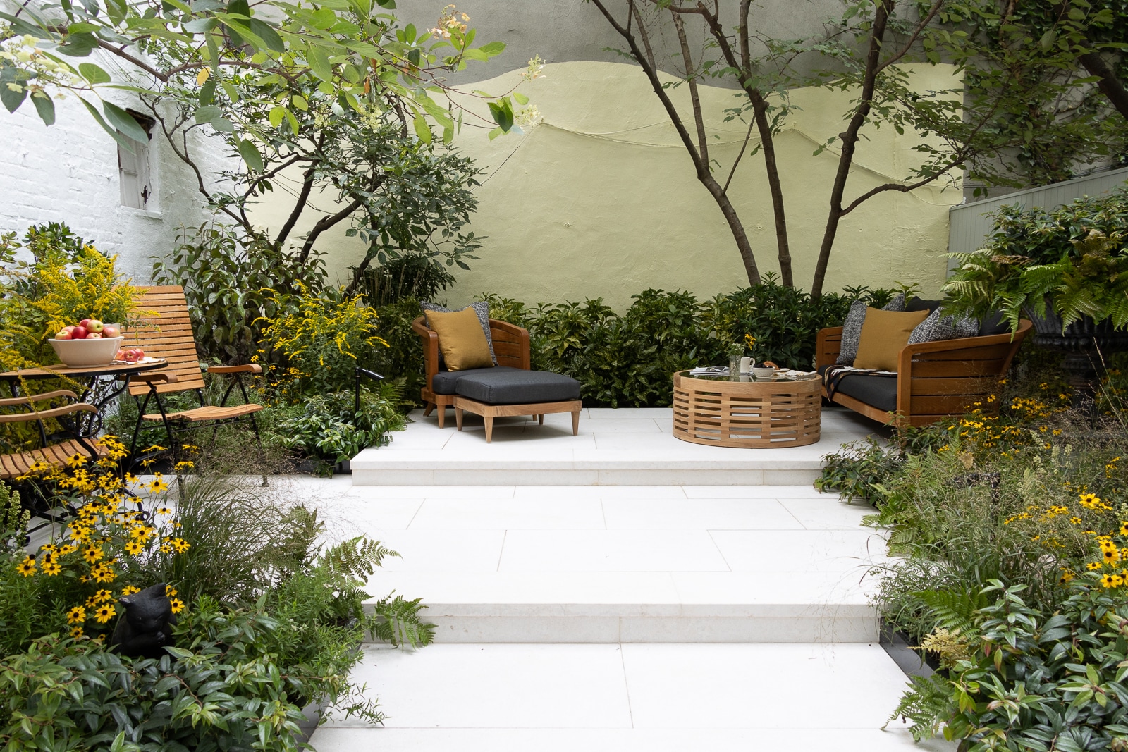 steps leading to a seating area surrounded by plants