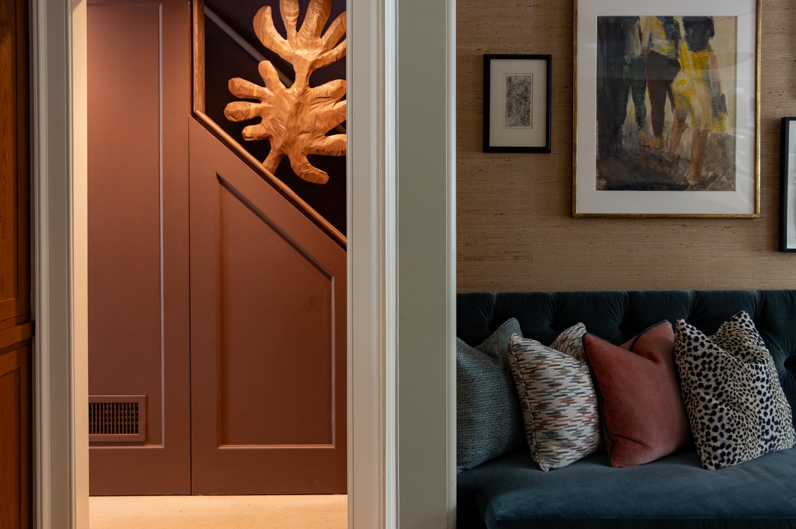 pillows on the banquette and a glimpse of the wood treatment on stair