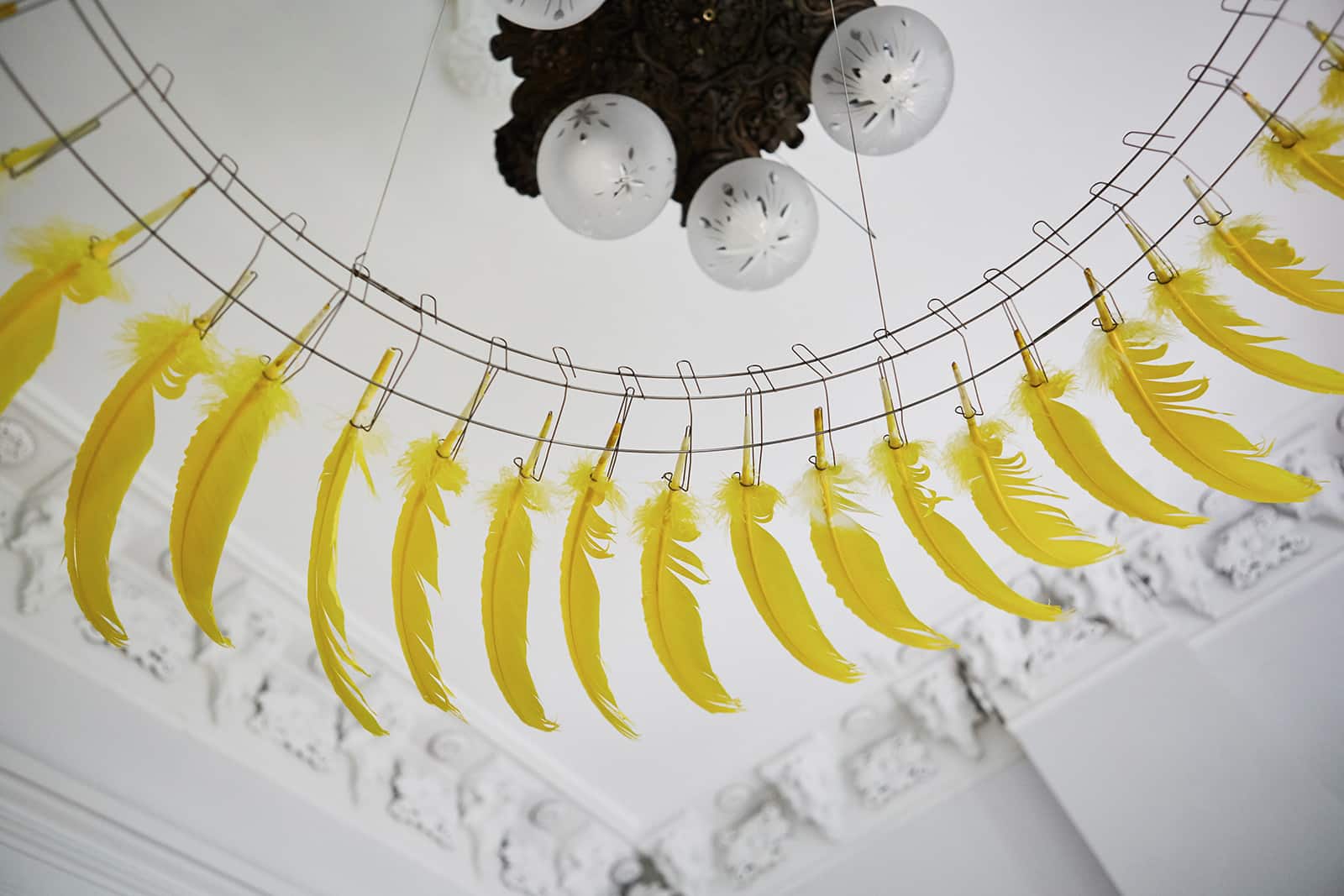  A ring of yellow feathers by kinetic sculptor Tim Prentice is a quirky touch, suspended from a fixture Galli believes is original to the house