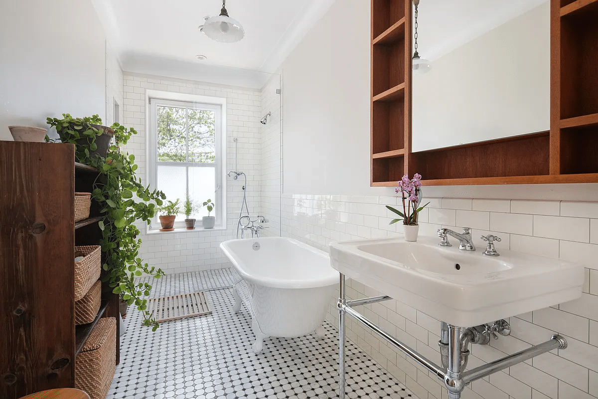 bathroom with black and white floor tile, claw foot tub and walk-in shower