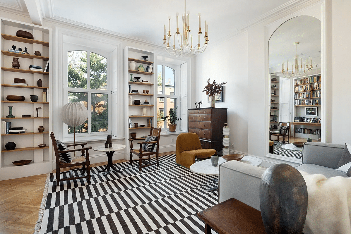 bedroom used as a sitting room with built-in shelves, wood floor