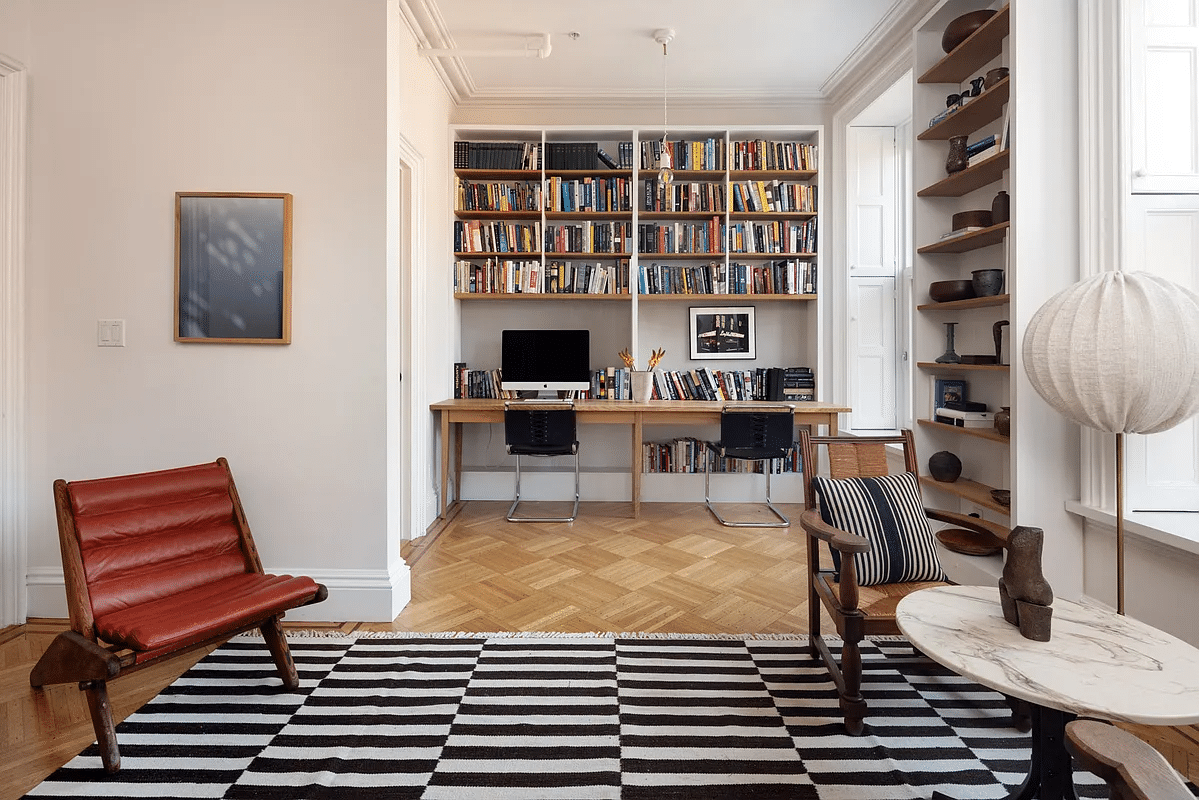 bedroom used as a sitting room with nook set up as a desk area