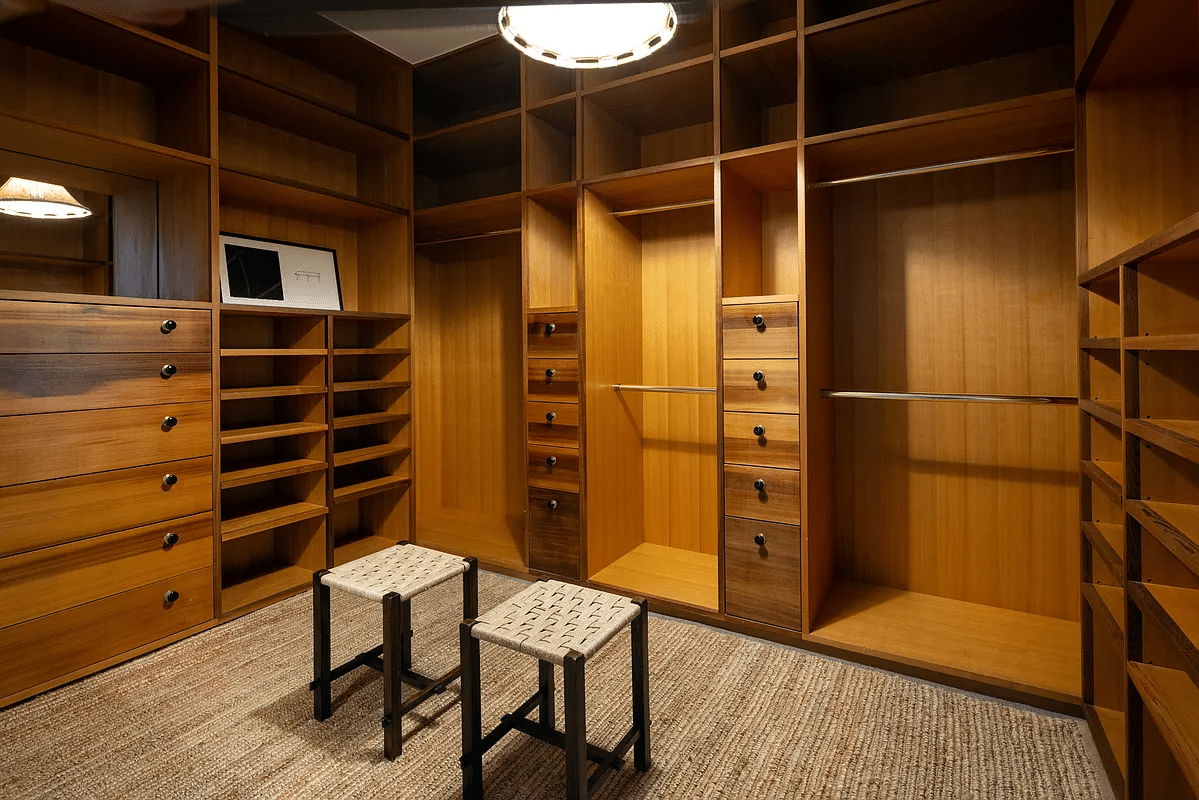 dressing room with wood built-in drawers and hanging space