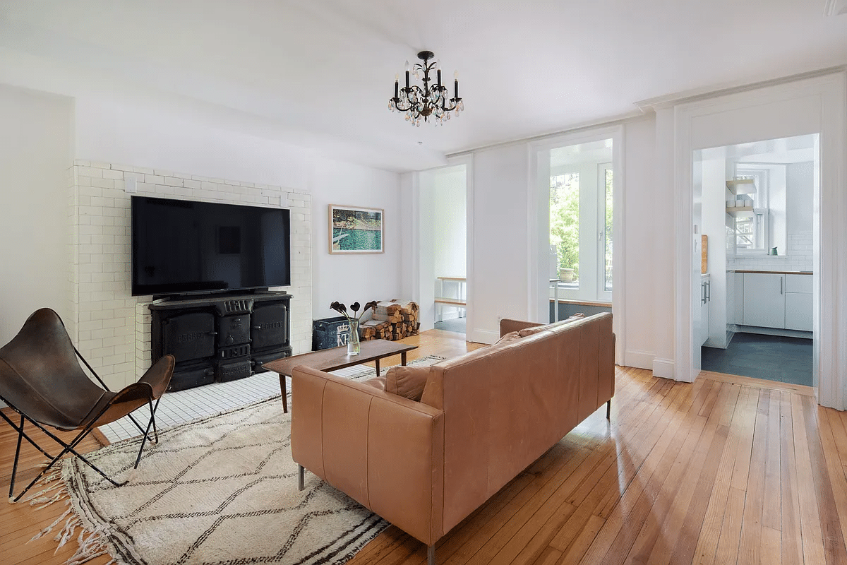 garden level living room with wood floor, antique stove