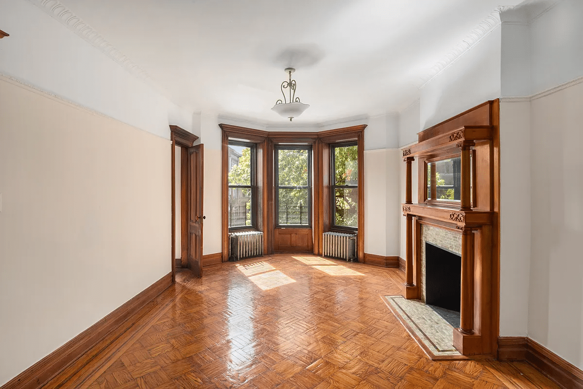 bedroom with mantel, wood floor