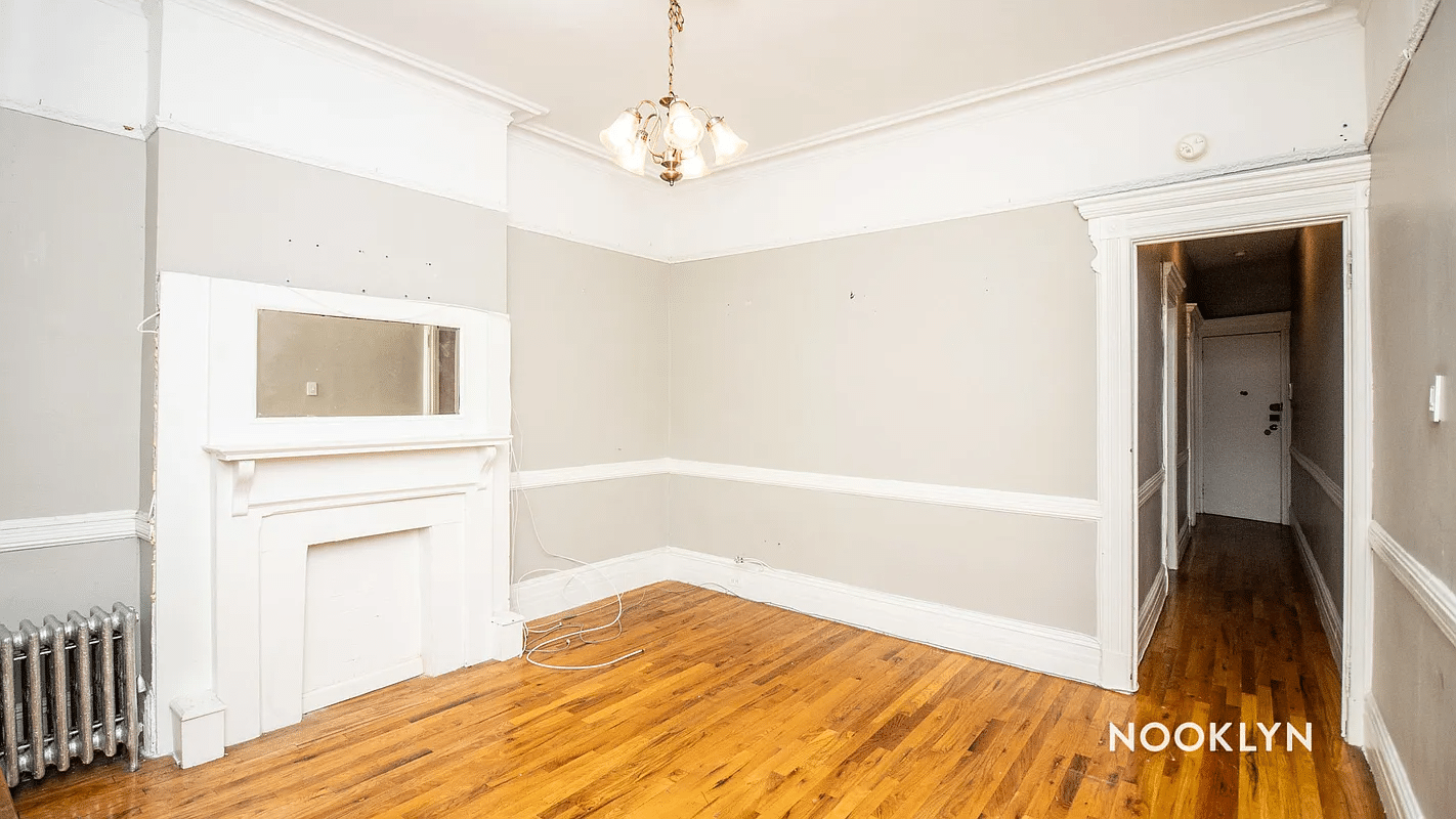 room with mantel, chandelier, picture rail