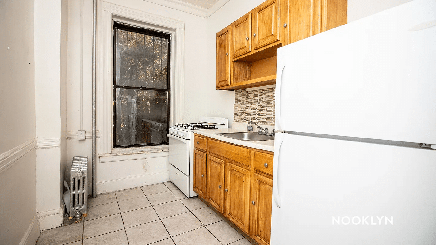 kitchen with beige tile floors, wood cabinets