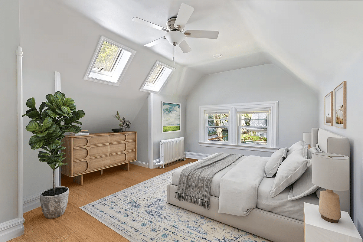 attic room with skylights staged as a bedroom