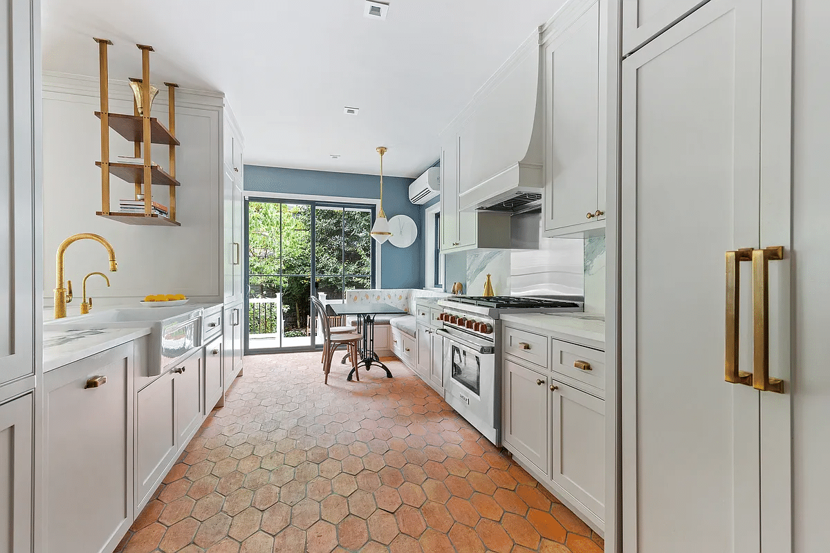 kitchen with terra cotta tile floor, white cabinets