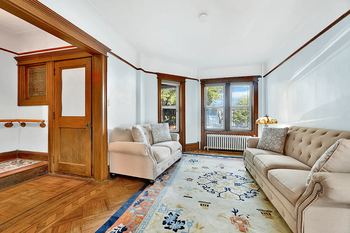 parlor with picture rail, wood floors