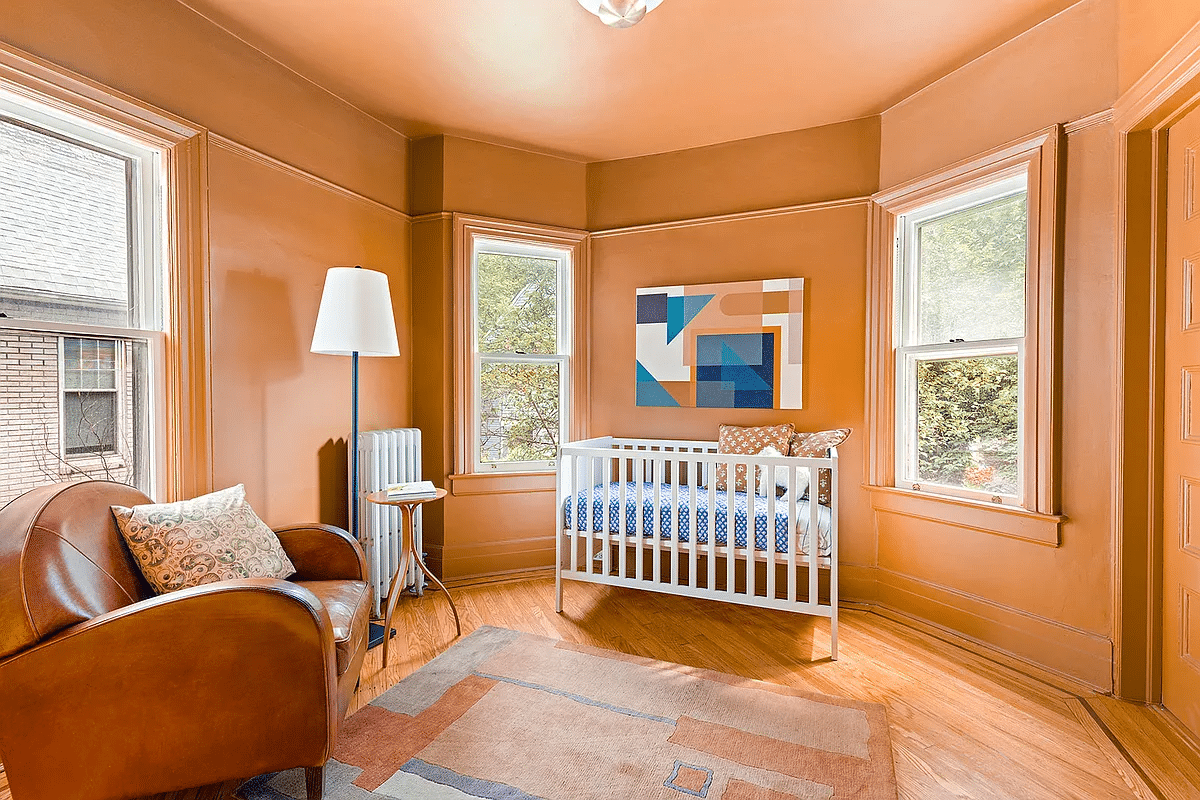 bedroom with peach walls, wood floor