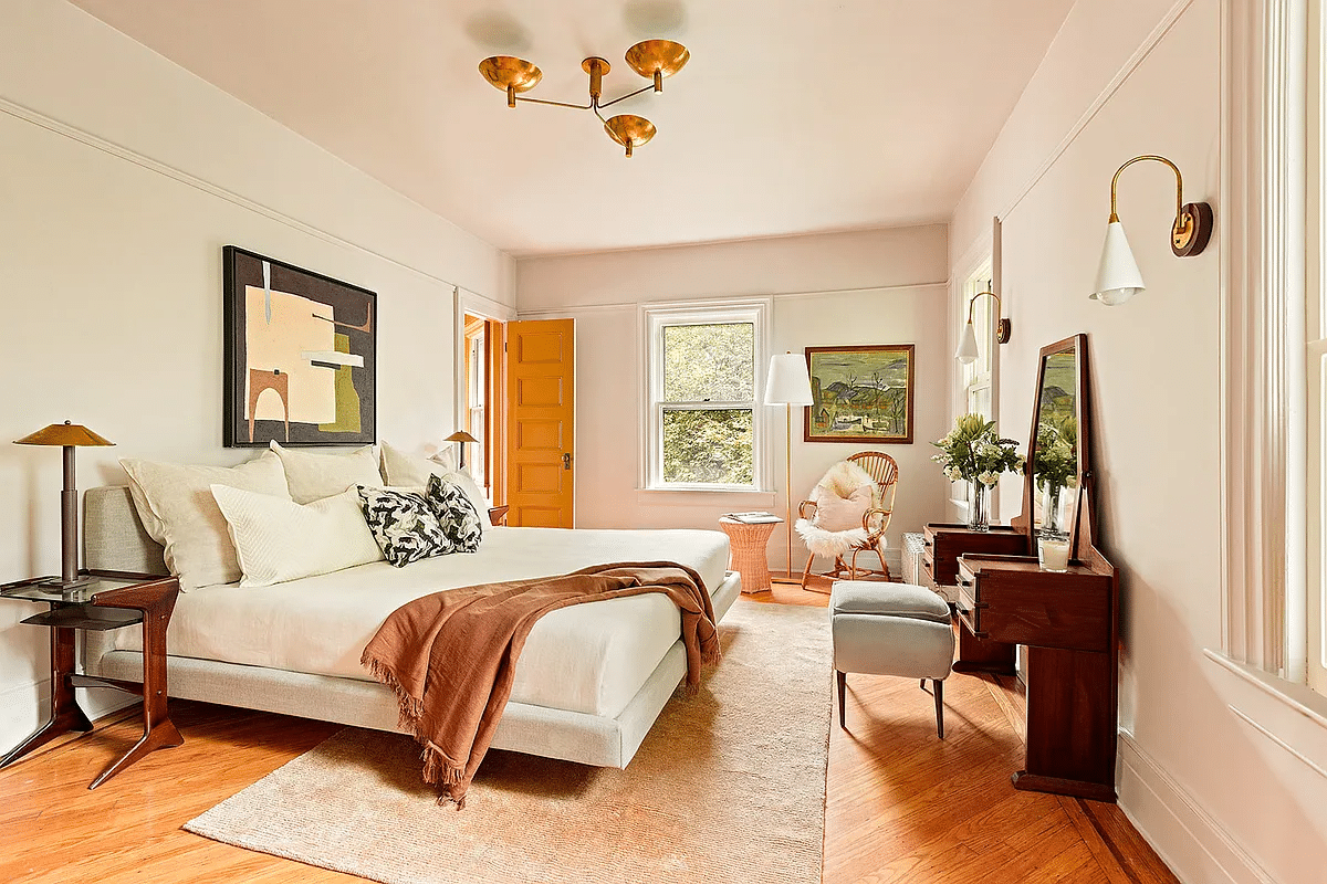 bedroom with picture rails, wood floor, two exposures