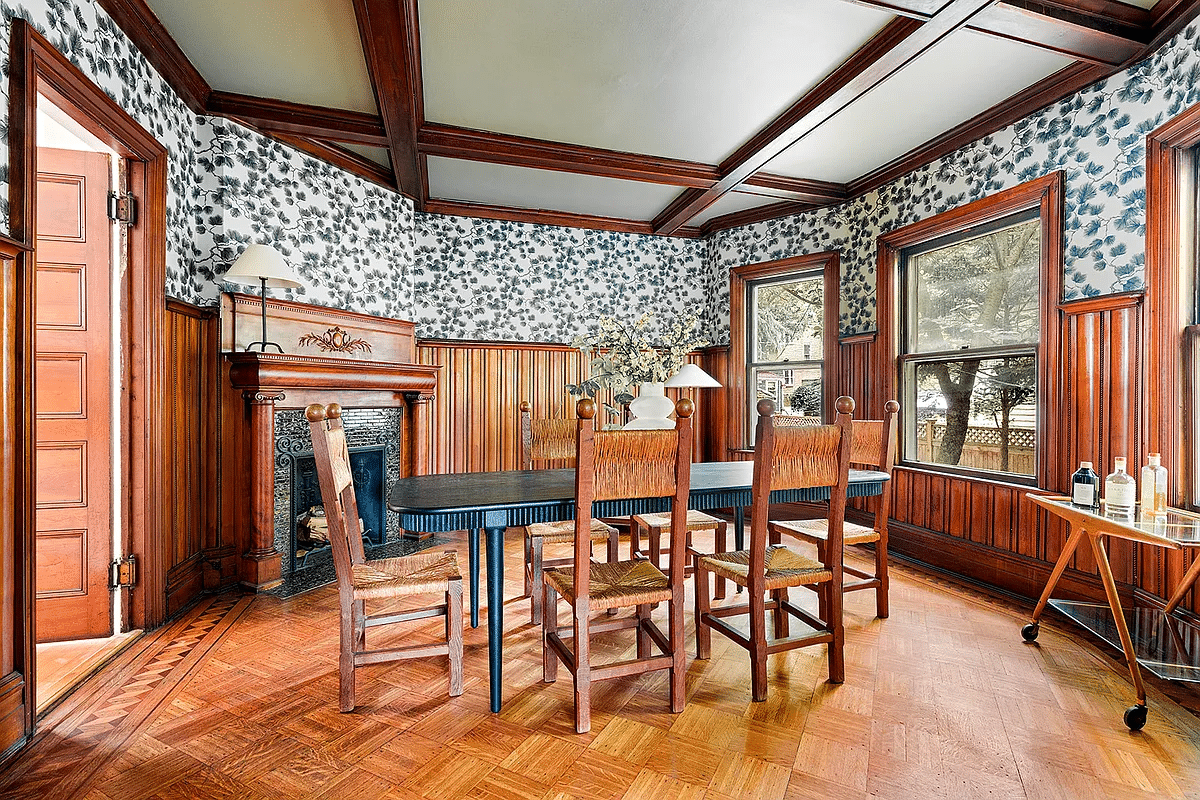 dining room with wainscoting, beamed ceiling, columned mantel