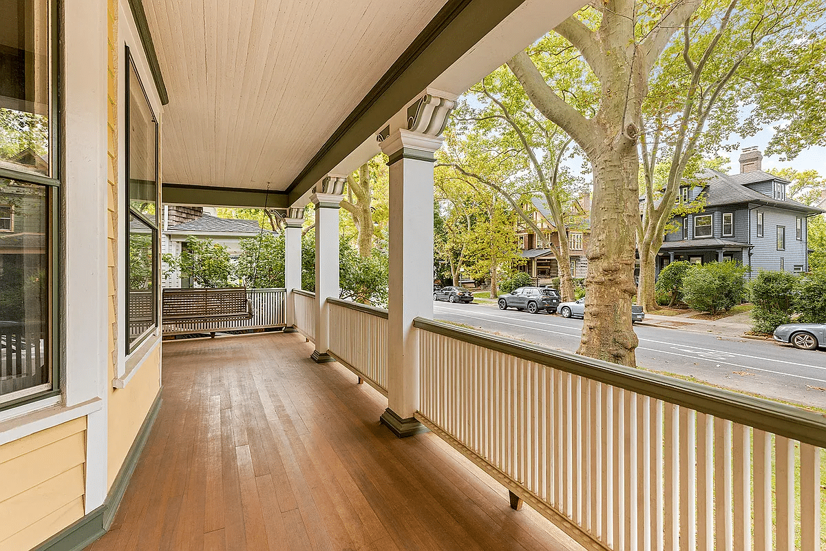 wraparound porch with a porch swing