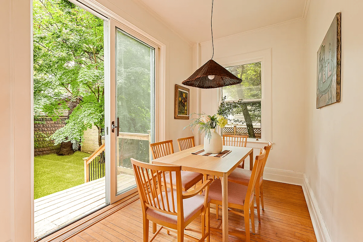 dining nook in kitchen with wood floor, sliding glass doors to yard