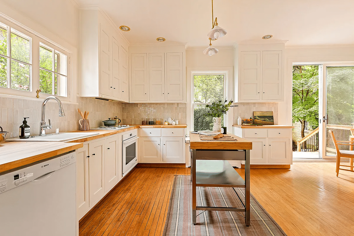 kitchen with white shaker style cabinets, butcher block cabinets